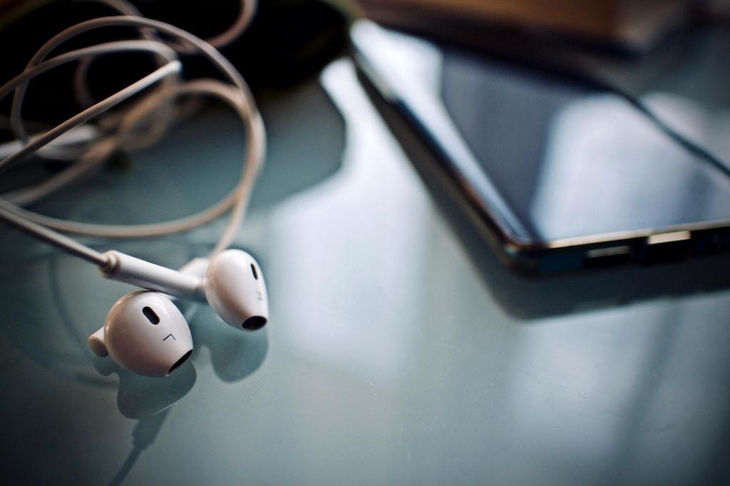Clean workspace with smartphone and notebook symbolizing communication