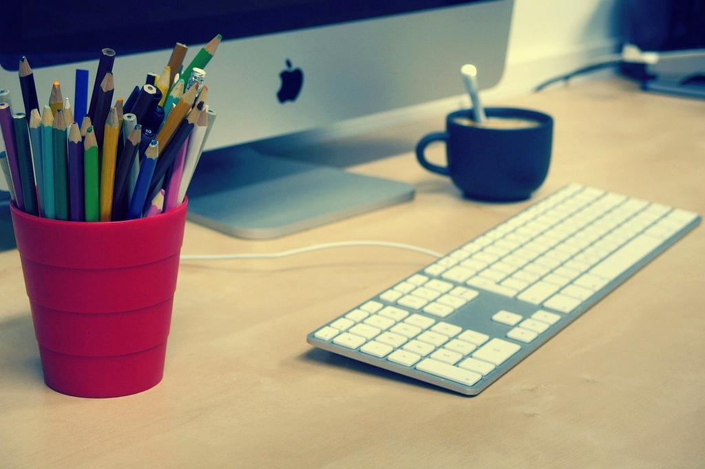 Stack of practical guidebooks with a notebook and coffee